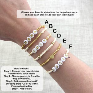 May include: A collection of personalized bracelets spelling out "MAMA", "LUCY", and "ROSIE" in white letter beads. Other bracelets feature gold beads and a gold heart charm. Instructions are included.