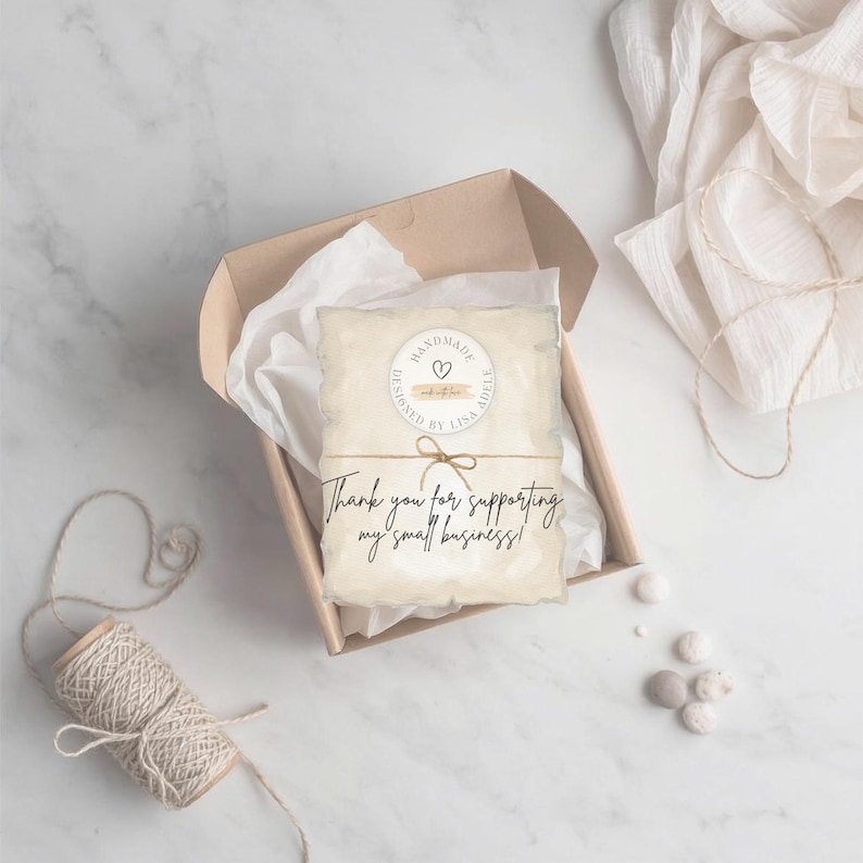 May include: A handmade gift box with a card that reads "Thank you for supporting my small business!" The card is tied with twine and features a circular design that says "Handmade by Lisa Adele". The box is filled with white tissue paper.