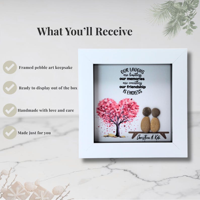 May include: A white framed pebble art keepsake with the text "OUR LAUGHS are limitless, our memories are countless, our friendship IS ENDLESS." The art features a pink heart-shaped tree and two pebble figures. Signed "Christine & Kate."