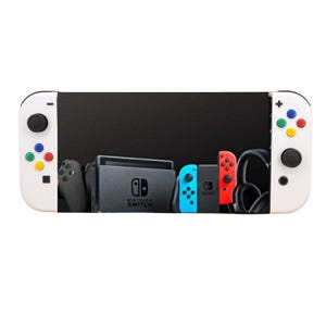 May include: A white Nintendo Switch console with colourful buttons on the controllers. The console is displaying a black screen with images of other Nintendo Switch controllers and a Nintendo Switch dock.