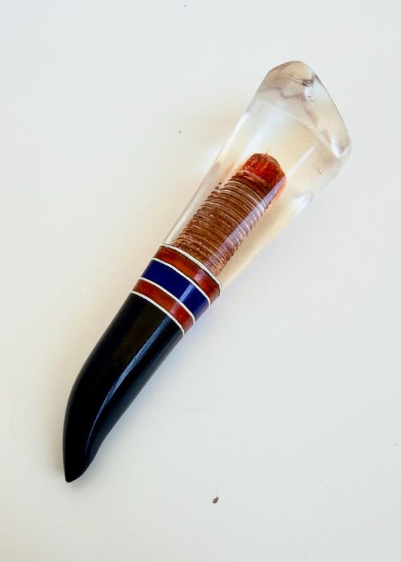 A hand-carved Lucite claw dip pen crafted by a Soviet-era prisoner — wearable history meets outsider art in one deeply unsettling, conversation-stopping object.