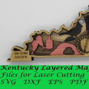 May include: A layered wooden map of Kentucky with a red cardinal, a banjo, a fiddle, a horse, and a raccoon. The map is designed for laser cutting and includes the text "United We Stand Divided We Fall".