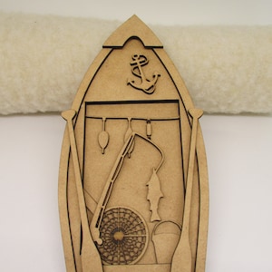May include: Wooden cutout of a boat with fishing gear, including a fishing rod, net, bucket, and fish. The boat has an anchor at the top and two oars on the sides.