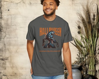 May include: A dark grey t-shirt featuring a werewolf graphic and the text "HALLOWEEN" in orange. The text below the graphic reads "It's not just a day, it is a state of mind."