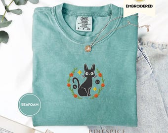 Jiji Black Cat Embroidered Comfort Colors® Tee – Whimsical Witchy Cat Shirt – Cozy Familiar Vibes for Book Lovers & Cat Companions