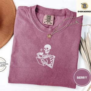 Embroidered Skeleton Reading a Book Shirt – Comfort Colors Book Lover Tee Cozy Aesthetic Embroidery Dark Academia Spooky Season Reader Shirt