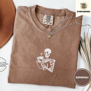 Embroidered Skeleton Reading a Book Shirt – Comfort Colors Book Lover Tee Cozy Aesthetic Embroidery Dark Academia Spooky Season Reader Shirt
