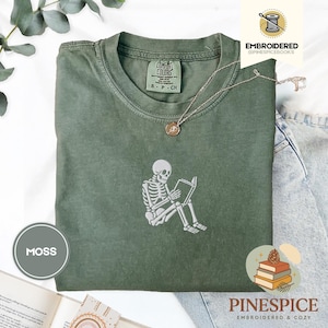 Skeleton reading book tee, embroidered skeleton coffee shirt, spooky book lover t-shirt, comfort colors 1717 fall vibes shirt, boo basket