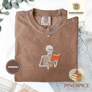 Skeleton reading book tee, embroidered skeleton coffee shirt, spooky book lover t-shirt, comfort colors 1717, fall vibes shirt, boo basket