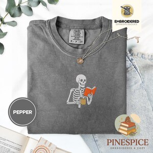 Skeleton reading book tee, embroidered skeleton coffee shirt, spooky book lover t-shirt, comfort colors 1717, fall vibes shirt, boo basket