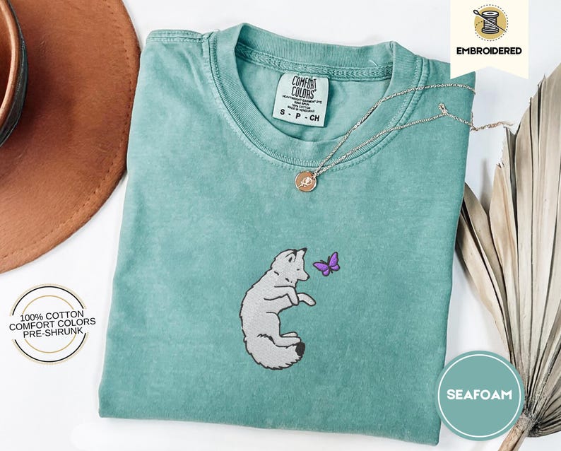Embroidered Snow Fox Onyx Quicksilver Book Comfort Colors Tee, Fae and Alchemy Little Osha Kingfisher Shirt, Cozy Cute Tee