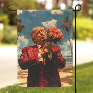 May include: A garden flag featuring a painting of a person in a red suit holding a bouquet of pink roses. The person is smiling and looking at the roses. The background is a blue sky with white clouds and palm trees.