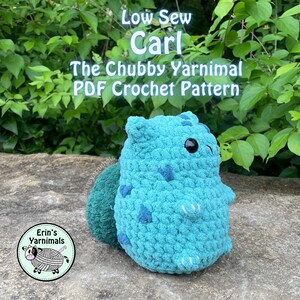 May include: A crocheted teal blue amigurumi toy named Carl, a low sew chubby yarnimal. The toy is sitting on a rock with green foliage in the background. The image includes the text "Low Sew Carl The Chubby Yarnimal PDF Crochet Pattern".