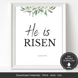 May include: White framed print with the words "He is RISEN" in black script and block letters, with "matthew 28:6" below. The top features a watercolor olive branch design. A circular "PDF INSTANT DOWNLOAD" graphic is in the lower right.
