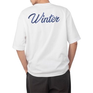 May include: White t-shirt with a blue embroidered "Winter" graphic on the back.