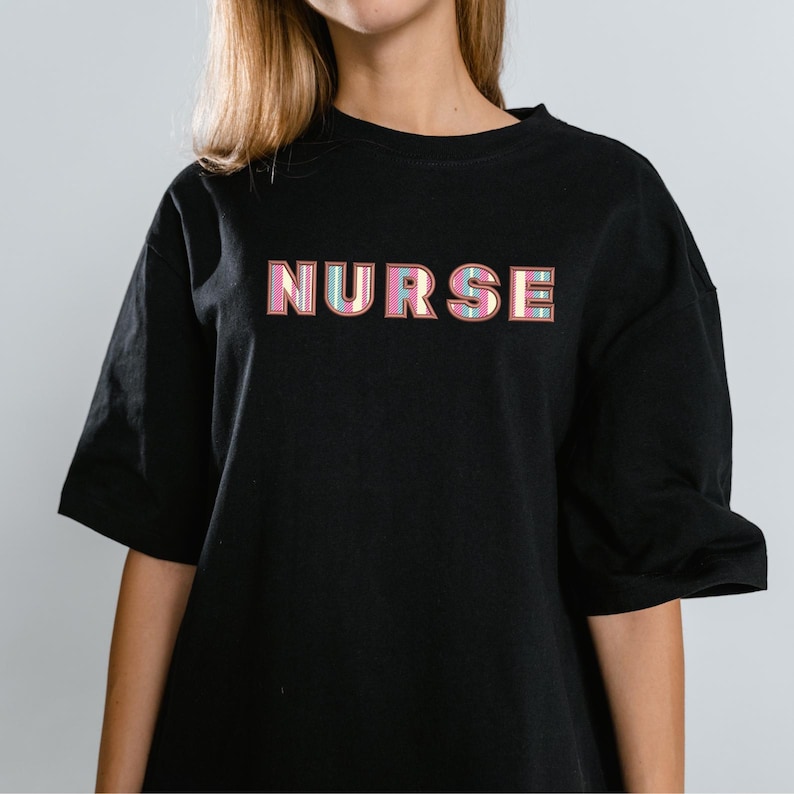 May include: Black t-shirt with the word "NURSE" printed in pink, blue and yellow letters.