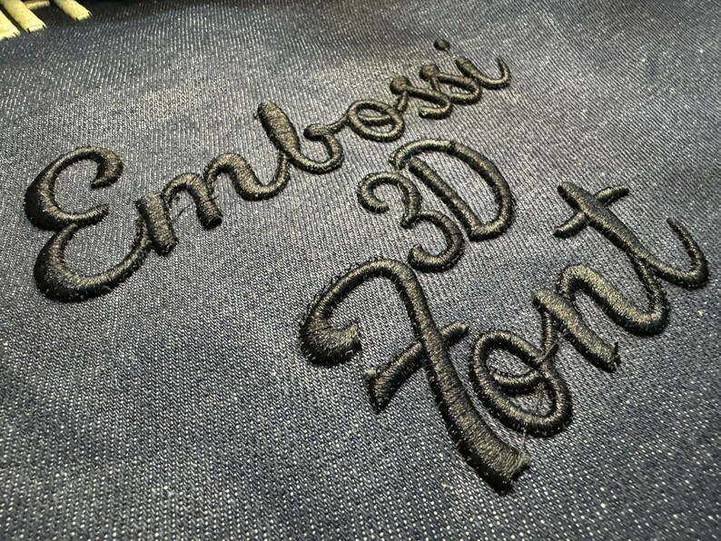 May include: Embroidered text on a blue fabric background. The text reads "Embroidered 3D Font".