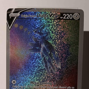 May include: A Pokemon trading card featuring Origin Forme Dialga V, a silver and blue Pokemon with a rainbow background. The card has a HP of 220 and two attacks: Metal Coating and Temporal Rupture.