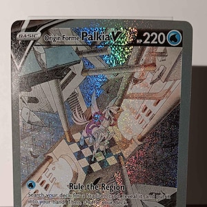 May include: A holographic Pokemon trading card featuring Palkia V, a blue and white mythical creature with a crown. The card is from the Sword & Shield - Brilliant Stars set and has a HP of 220. The card text reads "Rule the Region" and "Hydro Break".