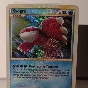 May include: A holographic Pokemon card featuring Kyogre, a blue and red water-type Pokemon. The card has a blue background with a holographic image of Kyogre. The card's text reads "Kyogre, HP 100, Basic, No. 382, Sea Pokemon, H: 14'09", WT: 776.0 lbs, Destructive Tsunami: Flip a coin. If heads, this attack does 40 damage to each of your opponent's Pokemon. If tails, this attack does 40 damage to each of your Pokemon. (Don't apply Weakness and Resistance for Benched Pokemon.)"