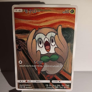 May include: A Japanese Pokemon trading card featuring a brown and white owl Pokemon with green leaves on its head. The card is set against a red, orange, and yellow background with black lines. The card text reads "たね モクロー HP60 さけび おおたがいのバトーリーがケモンが、それぞれこんらんにする。"