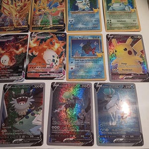 May include: A collection of ten holographic Pokemon trading cards featuring various characters, including Blastoise, Venusaur, Charizard, and Pikachu. The cards are in excellent condition and have a shiny, iridescent finish.