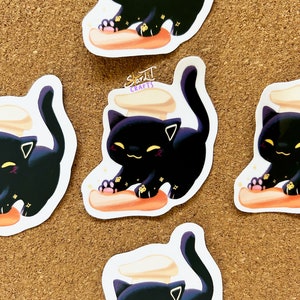 Sticker chat faisant des biscuits