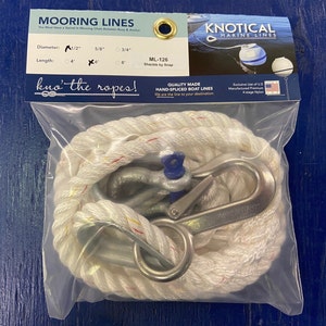 May include: White mooring line with red and yellow accents, a shackle, and a snap hook. The line is packaged in a clear plastic bag with a label that reads "Mooring Lines" and "KNOTICAL MARINE LINES". The label also includes the text "ML-126 Shackle by Snap" and "Quality Made Hand-Spliced Boat Lines".