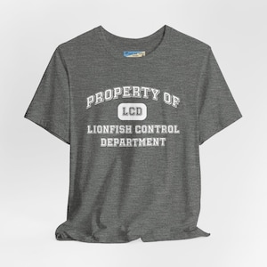 May include: A heather gray t-shirt with white text that reads "PROPERTY OF LCD LIONFISH CONTROL DEPARTMENT".