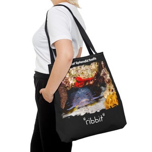 May include: Black tote bag with a colorful image of a fish with the text "The Splendid Toadfish" and "ribbbit" printed on it.