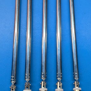 May include: Five silver telescopic antennas with a BNC connector base are arranged vertically against a blue background. The antennas are fully extended, showcasing their segmented design. The connectors have a textured, metallic finish.