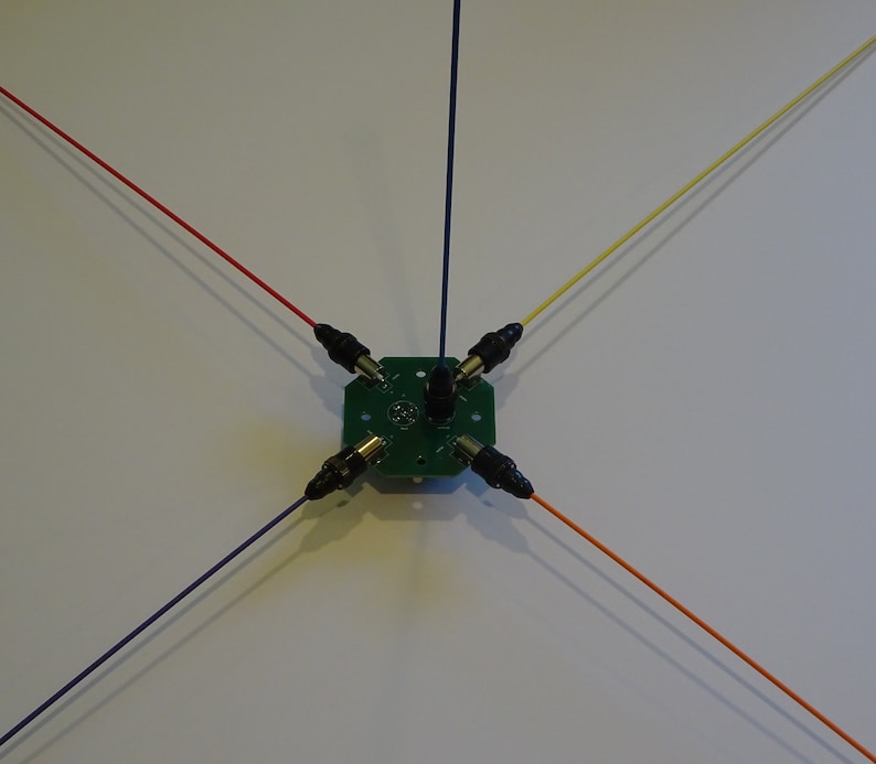 May include: A green circuit board with five wires attached. The wires are red, blue, yellow, orange, and purple. The wires are connected to the circuit board with black connectors.