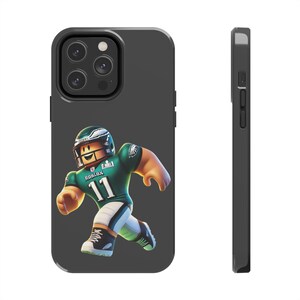May include: Black phone case with a green, white, and black Roblox character wearing a football uniform and helmet. The character is running and has the number 11 on their jersey. The text "ROBLOX" is on the jersey.
