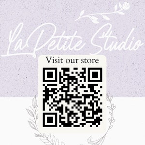 May include: A white and purple background with the text "La Petite Studio" in white cursive script. Below the text is a white square with a black QR code and the text "Visit our store" in black.