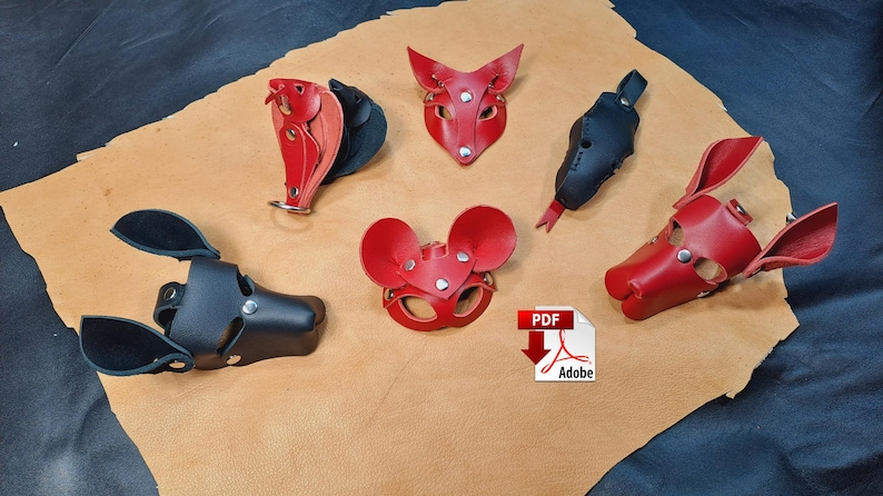 May include: A collection of five leather animal-themed masks and accessories in red and black. The set includes a black dog-style mask, a red mouse-style mask, a red fox-style mask, a black elongated accessory, and a red animal-shaped piece.