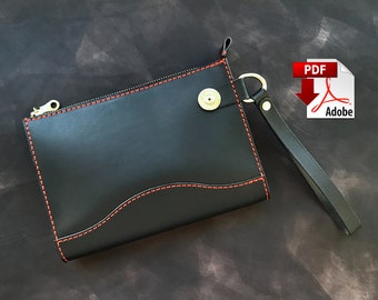 May include: Black leather clutch with a red stitch detail and a gold snap closure. The clutch has a wrist strap and is made of high-quality leather.