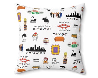 May include: White throw pillow with a colorful pattern featuring iconic images and text from the TV show "Friends". The pattern includes the Central Perk logo, the iconic orange couch, the words "We were on a break", "Pivot", and "He is her lobster", and images of the show's characters.