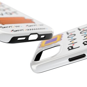 May include: Two white phone cases with black trim. One case features a cartoon image of the iconic orange couch from the TV show Friends, with the text "Shut Up" and "Shut Up" repeated. The other case features the text "PIVOT" and "I'LL BE THERE FOR YOU" in black.