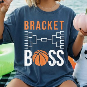 May include: A set of three ceramic mugs with a speckled, matte finish. The mugs are in shades of cream, light gray, and dark gray. Each mug has a simple, minimalist design and a rounded handle.