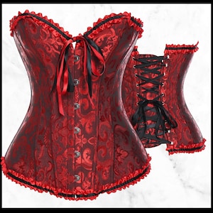 May include: A red satin corset with black lace trim and a black ribbon bow. The corset has a busk closure at the front and lace-up back.