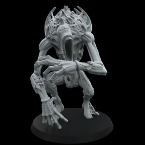 May include: A light grey unpainted miniature figurine of a creature with a hunched posture, elongated limbs, and a large, textured head with an open mouth. The figure stands on a circular black base, displaying intricate organic details.