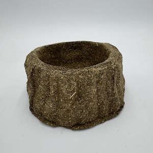 May include: A brown, round, woven bowl made of natural materials. The bowl has a rough, textured surface and is perfect for holding small items.