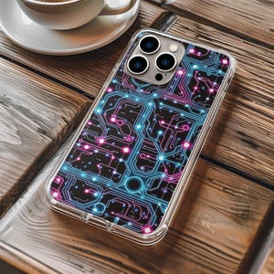 May include: Clear phone case with a circuit board design in blue and pink. The case is on a wooden table next to a cup of coffee in a white cup and saucer.
