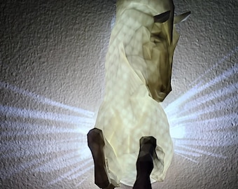 May include: A white origami horse sculpture with a light shining through it, casting a pattern of light on the wall behind it.