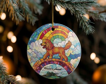 May include: Circular Christmas ornament depicting a golden poodle on a rainbow bridge. The design has a stained-glass appearance, with a rainbow, clouds, and the text "Forever Loved Princess". The ornament is suspended by a gold cord.