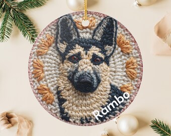 May include: A round ceramic ornament featuring a German Shepherd dog portrait with the name "Rambo" in white script. The dog's face is detailed with black, tan, and brown colors. The ornament has a gold hanging loop and is surrounded by decorative elements.