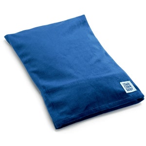 May include: A blue corn husk pillow with a white label that says "TOWA CORN BABY".