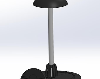 May include: A black helmet stand with a skull and wings logo. The stand has a round top and a base with a circular design.