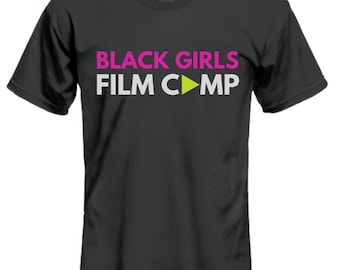 May include: Black t-shirt with the text "BLACK GIRLS FILM CAMP" in white letters with a pink outline and a green play button.