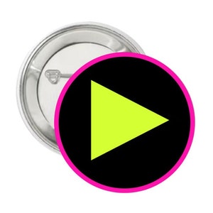 May include: A black button with a pink border and a bright yellow play button in the center.